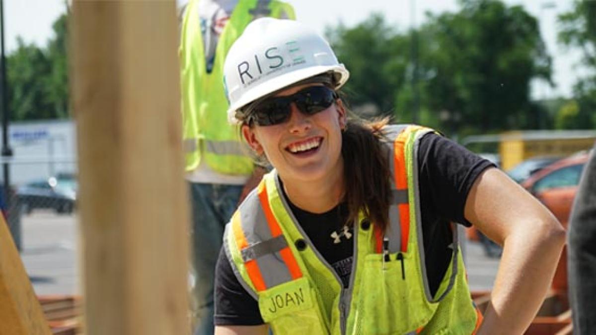 DU engineering student with hardhat and vest on job site