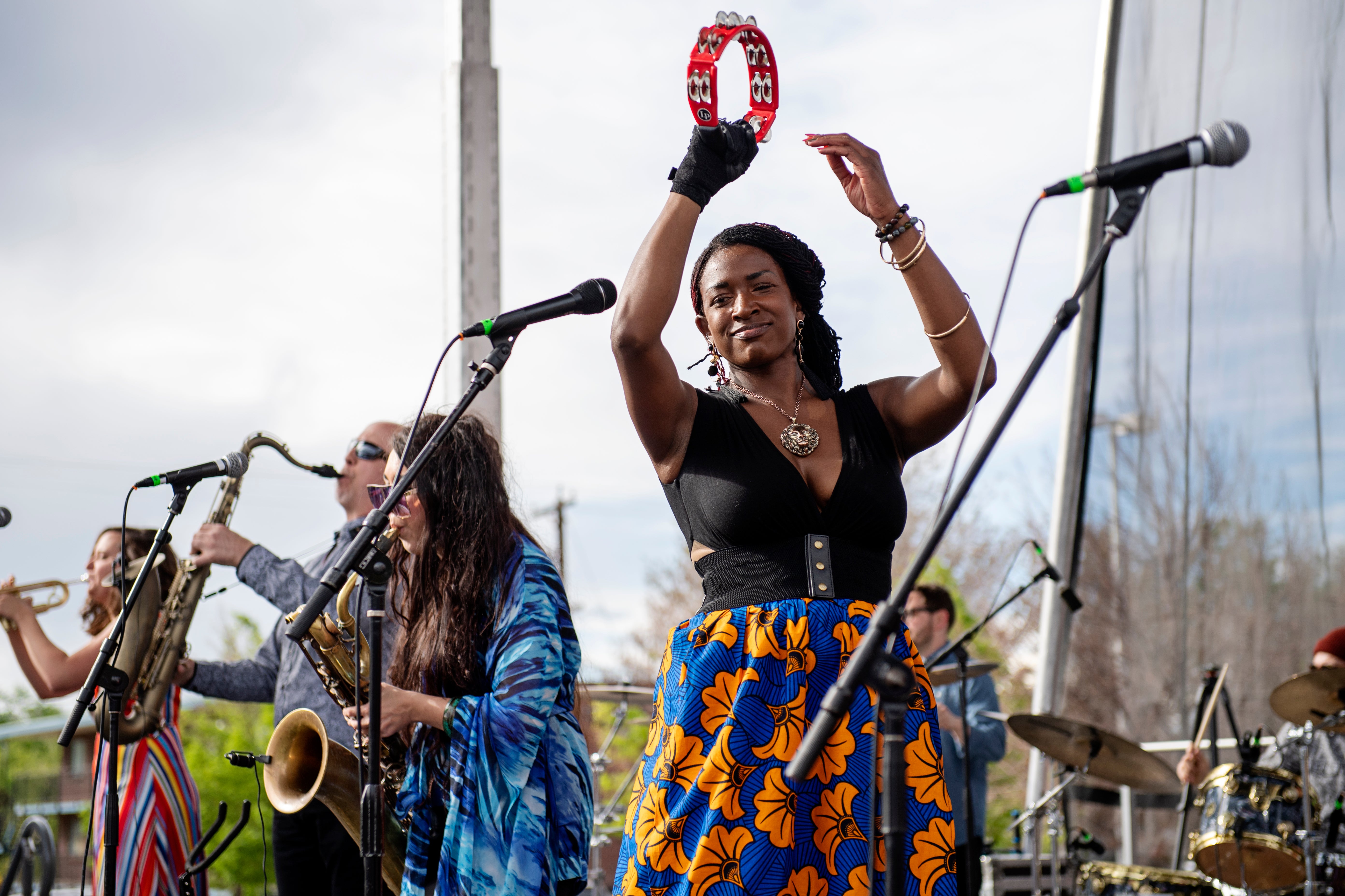 Performers use tambourines on stage.