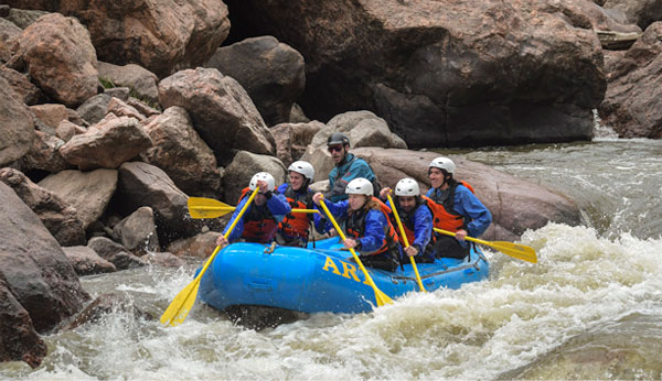 group rafting in river rapids
