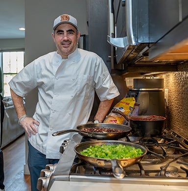 Alex Demopoulos poses for a photo during a cooking event with the DU men's lacrosse team.