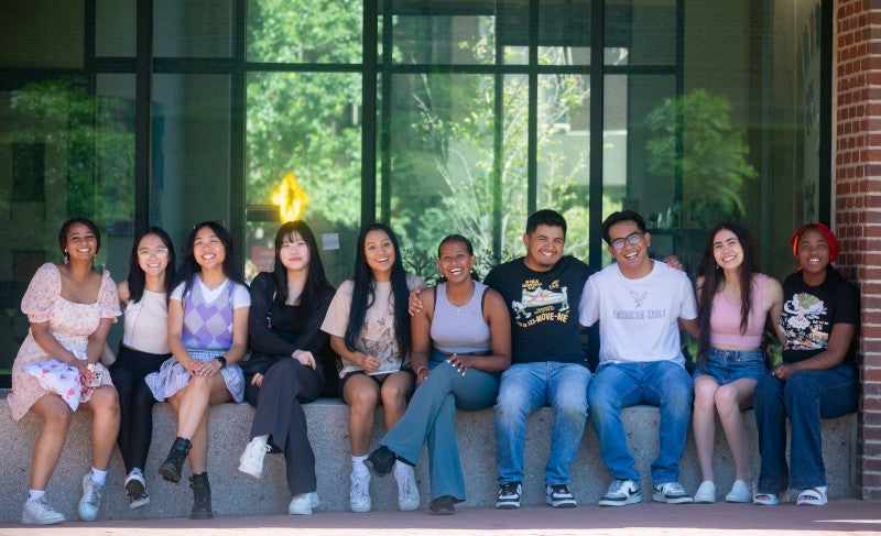 Students sitting on wall