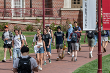 Students walking on a brick path through DU's campus