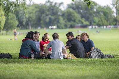 A group of students sitting in Washington Park