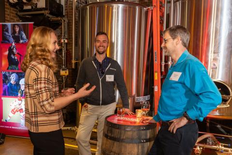 A group of University of Denver alum talk together.