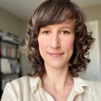 Jan profile photo in an office in front of a bookcase. 