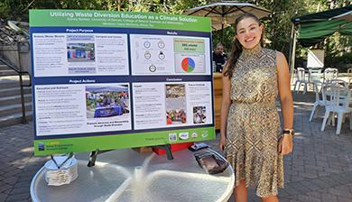 Sidney Barbier stands next to her poster presentation.