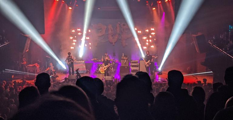 A band performing on stage at the Ogden