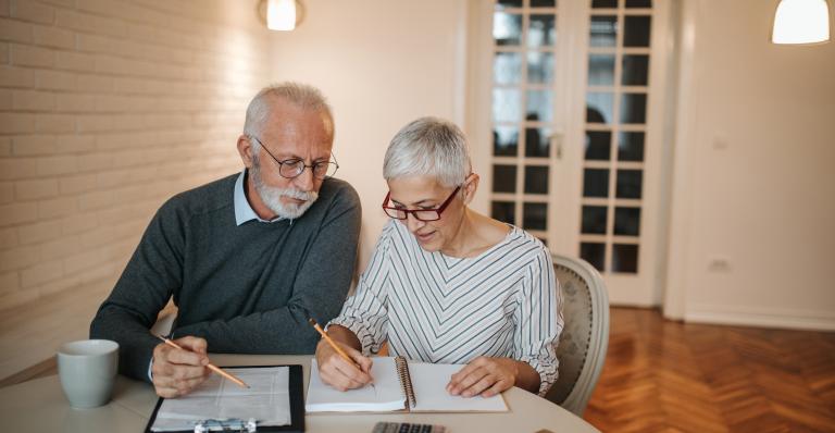 Two people look over financial documents.