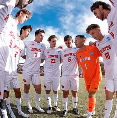 The men's soccer team huddles before a game.