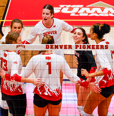 The volleyball team huddles during a match.